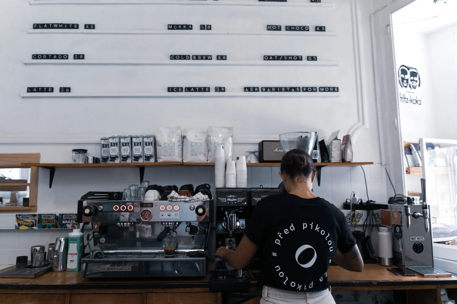 Buna team members smiling behind coffee counter
